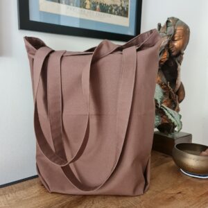 a handmade brown tote bag with olive green stitching detail